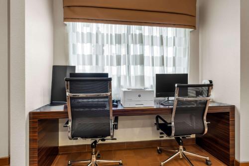 an office with two chairs and a desk with two monitors at Sleep Inn & Suites West-Near Medical Center in Rochester