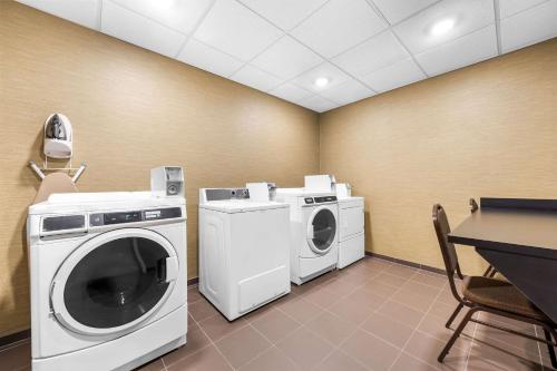 a laundry room with a washer and dryer at Sleep Inn & Suites West-Near Medical Center in Rochester