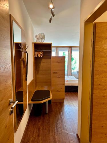 a room with a cupboard and a bedroom with a bed at Ferienwohnung Gabriel in Rust