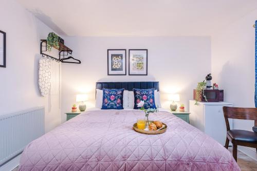a bedroom with a bed with a bowl of fruit on it at Victoria Park Studio 11 - Free Parking, WiFi, Near Town Centre, Free DisneyPlus, Prime & Netflix in Leamington Spa