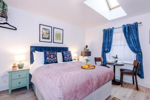 a bedroom with a bed with a bowl of fruit on it at Victoria Park Studio 11 - Free Parking, WiFi, Near Town Centre, Free DisneyPlus, Prime & Netflix in Leamington Spa
