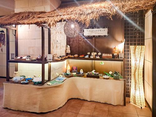 a room with a table with food on it at Hotel Asian Resort in Kōtōdaitōri