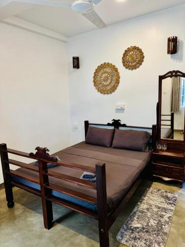 a bedroom with a bed and a mirror on the wall at Santino Mirissa in Mirissa
