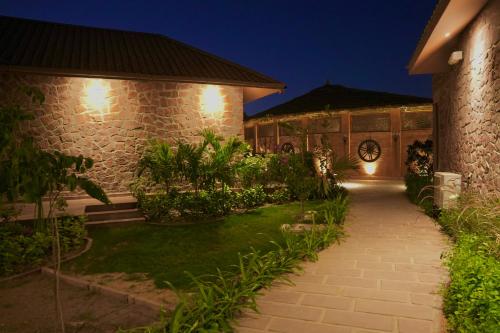 a pathway leading to a house at night at Surpura Bagh - A Luxury Boutique Resort in Jodhpur