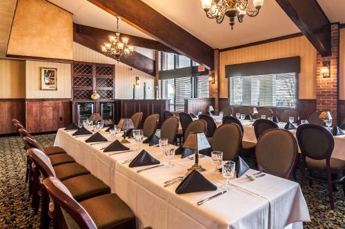 a conference room with tables and chairs and a chandelier at Clarion Inn Harpers Ferry-Charles Town in Harpers Ferry