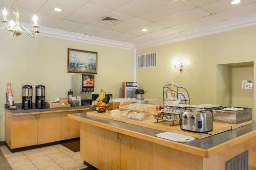 a kitchen with a counter with aasteryasteryasteryasteryasteryasteryasteryasteryastery at Clarion Inn Harpers Ferry-Charles Town in Harpers Ferry