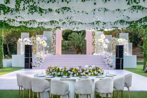 a table set up for a wedding reception with flowers at Hilton Cairo Heliopolis Hotel in Cairo