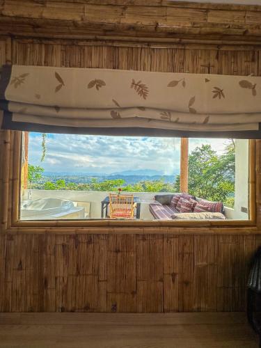 a window in a room with a view at Phu Chaisai Chiang Rai Mountain Resort in Mae Salong Nai
