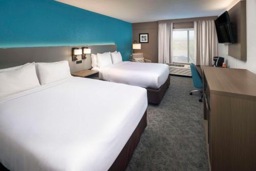 a hotel room with two beds and a television at Comfort Inn & Suites Dahlonega University Area in Dahlonega
