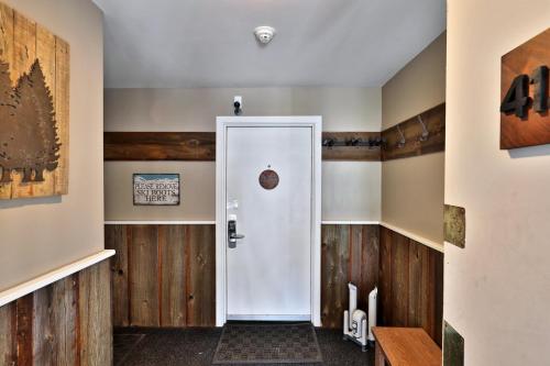 a hallway with wood paneling and a white door at Tranquil Peaks Studio at KCIS - Perfect for a Getaway in the Heart of Vermont Ski Resort in Killington