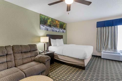 a hotel room with a bed and a couch at Clarion Pointe in Jasper