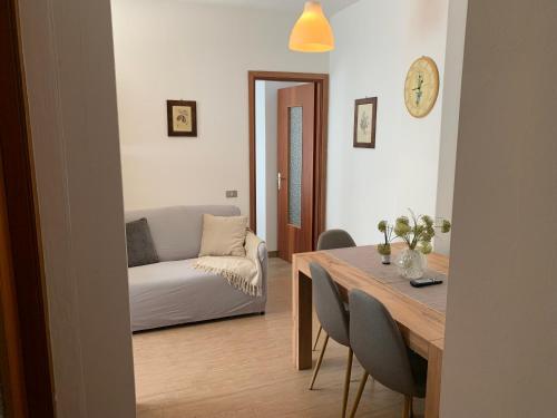a living room with a table and a couch at Casa pineta in Santa Maria Maggiore