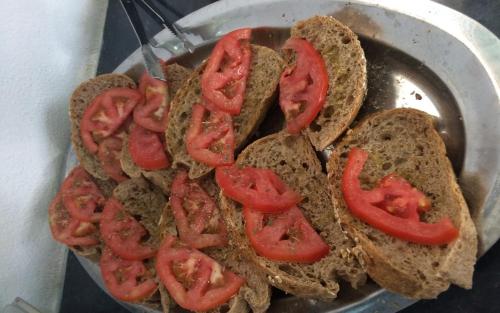 a bunch of sandwiches with tomatoes on them in a pan at Small Economy Studio Agia Pelagia - Crete in Agia Pelagia