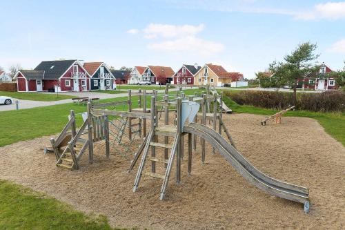 a playground with a slide in a park at Charming Terraced House By The Beach And Forest in Bro