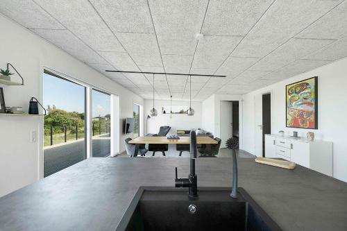 a kitchen and dining room with a table in a room at Modern Holiday Home On Adventurous Bornholm in Allinge