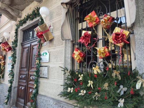 a window with christmas trees and presents on it at Bed & Breakfast Tiffany in Domodossola