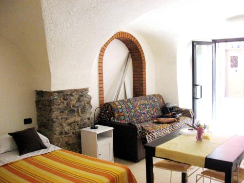 a living room with a couch and a table at Nino Bixio Apartment in Riva Ligure