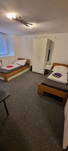 a room with two beds and a table in it at Paulibude in Hamburg
