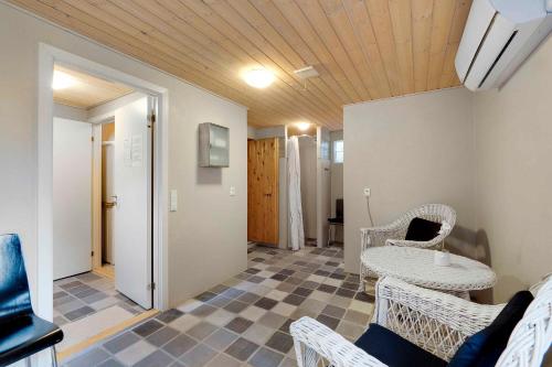 a living room with wicker chairs and a table at Beautiful House, 1St Row To The Water in Fur