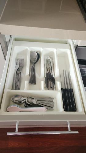 a drawer filled with silver utensils in a drawer at Capel Sands Beachfront Apartment in Capel Sound