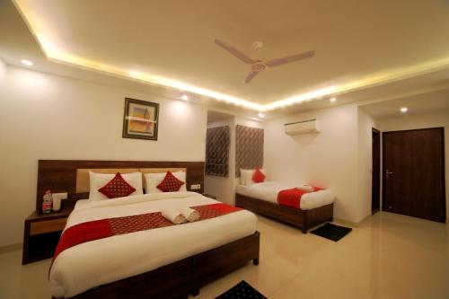 a bedroom with two beds and a ceiling fan at Hotel Chanakya Inn in New Delhi
