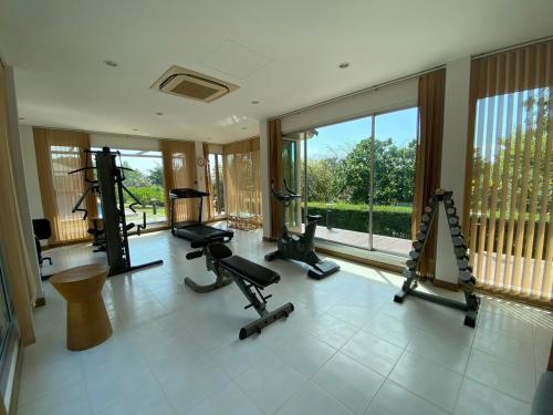 a gym with several treadmills and machines in a room at เดอรำพึง De Ramphueng ชายหาดแม่รำพึง ระยอง in Ban Chak Phai