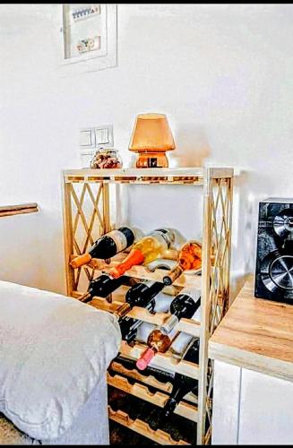 a room with a shelf filled with bottles of wine at Villa Pialia in Piáleia