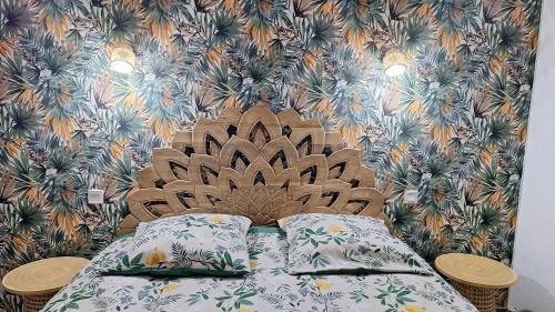 a bed with pillows in front of a wall at Vacance et Cure dans Duplex 80 M2 à CERET 66400 in Céret