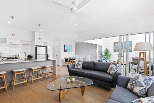 a living room with a couch and a table at Stylish 3BR Townhouse CampHill - WiFi, Parking in Brisbane