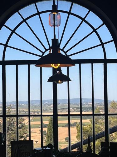a window with a view of the countryside from a chandelier at Villa Schiatti in Cortona