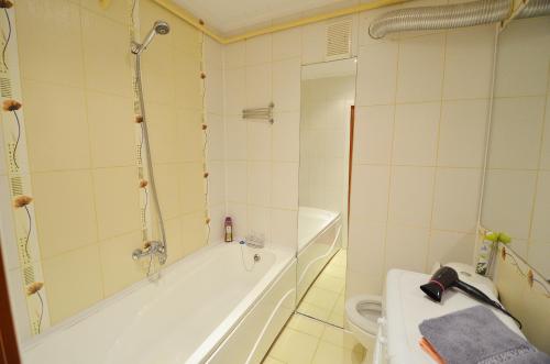 a bathroom with a bath tub and a toilet at Apartment Style on Sobornaya Street in Mykolaiv
