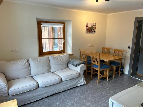 a living room with a couch and a table at Appartementhaus Gastein / Haus Sammie in Bad Gastein