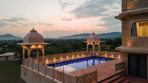 an outdoor swimming pool with a gazebo at Traavista Aravali Mahal - Luxury Lake View Heritage Resort in Udaipur in Udaipur