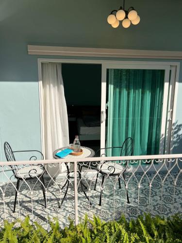 a table and chairs on the balcony of a house at Dusita Residence in Bangkok