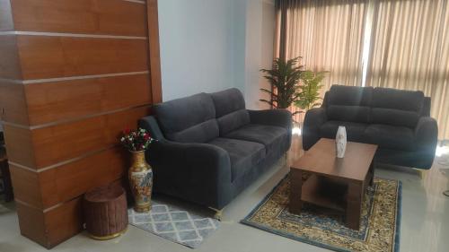 a living room with a couch and a table at 3 bhk near lulu mall kochi in Cochin