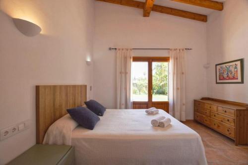 a bedroom with a large bed with a window at Correfoc ETV2963 Ubac Pollença in Sa Pobla