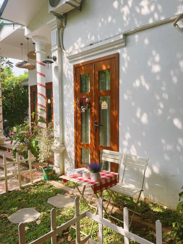 a table and chairs in front of a house at 1.Hôme in Hanoi
