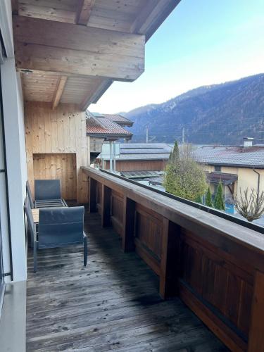 a balcony with a bench and a chair on a building at Penthouse Sonnenplatzl in Radfeld