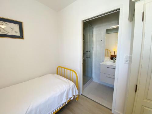 a bedroom with a bed and a bathroom with a mirror at VILLA MAJOY - Vue sur le port La Trinite - T547 in La Trinité-sur-Mer