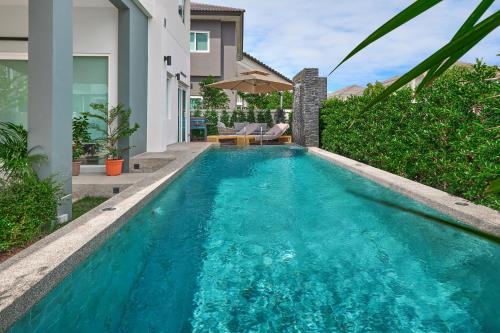 a swimming pool in the backyard of a house at Phuket Paradise Retreat in Phuket
