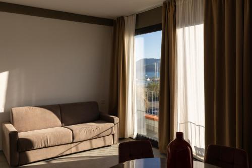a living room with a couch and a large window at Associazione Garage24 Aps Ets in Portoferraio