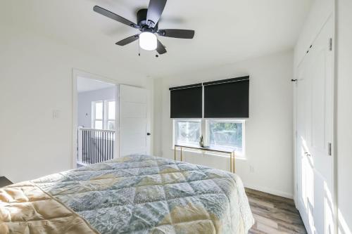 a bedroom with a bed and a ceiling fan at Luxury Sky View and Balconies in Baytown