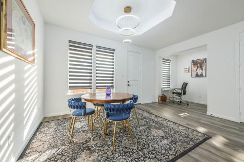 a dining room with a table and blue chairs at Luxury Sky View and Balconies in Baytown