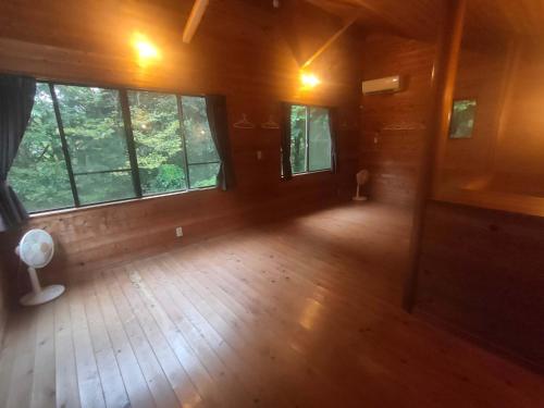 an empty room with large windows in a cabin at 南伊豆ランドホピア Minami Izu Land Hopia in Minamiizu