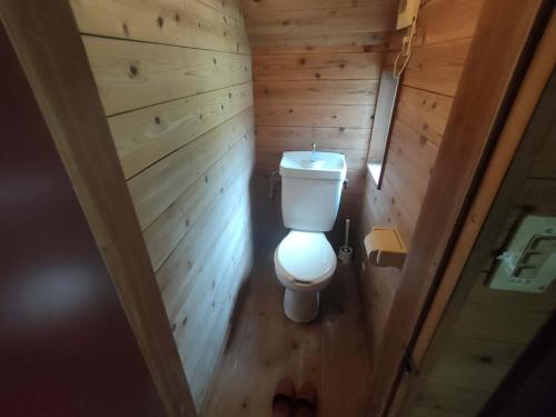 an overhead view of a toilet in a wooden bathroom at 南伊豆ランドホピア Minami Izu Land Hopia in Minamiizu