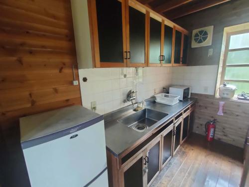 a kitchen with a sink and a refrigerator at 南伊豆ランドホピア Minami Izu Land Hopia in Minamiizu
