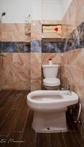 a bathroom with a white toilet in a room at Casa Mariana in Las Terrenas