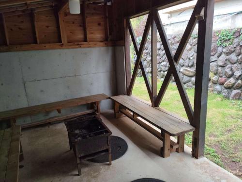a wooden bench in a room with a window at 南伊豆ランドホピア Minami Izu Land Hopia in Minamiizu