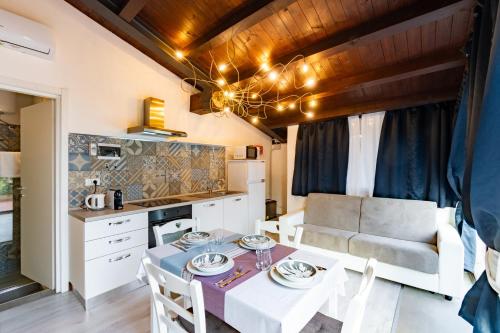 a kitchen and dining room with a table and a couch at Sweet Dreams in Peschiera del Garda
