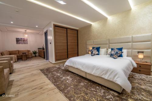 a bedroom with a large bed and a living room at Luxury Chaouen in Chefchaouene